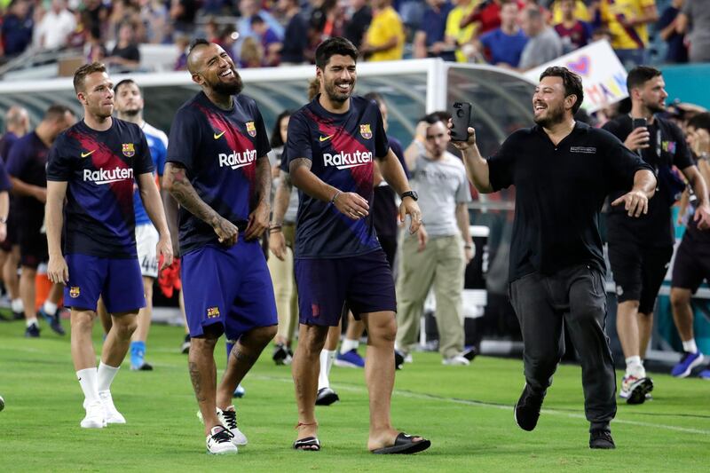 Luis Suarez, centre, was in relaxed spirits. AP Photo