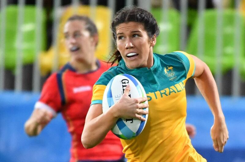 Australia's Charlotte Caslick runs with the ball in the women’s rugby sevens quarter-final match between Australia and Spain during the Rio 2016 Olympic Games at Deodoro Stadium in Rio de Janeiro on August 7, 2016. Pascal Guyot / AFP 