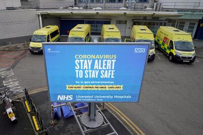 LIVERPOOL, UNITED KINGDOM - JANUARY 05:  Ambulances line up as government sponsored electronic sign gives out coronavirus pandemic information to visitors and staff outside the Royal Liverpool University Hospital on January 05, 2021 in Liverppol, United Kingdom. The Prime Minister yesterday announced a new lockdown with tougher Covid-19 measures following a sharp increase of cases, driven in part by a new variant of the virus that officials say is more infectious. (Photo by Christopher Furlong/Getty Images)