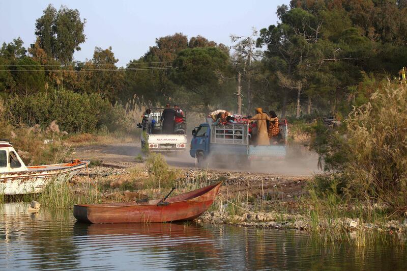 Displaced civilians on the bck of a lorry after after being rescued on a makeshift ferry by members of the US-backed Syrian Democratic Forces (SDF) through a water corridor at Lake Assad, a reservoir created by the Tabqa dam, on April 29, 2017. The ferry also serves as a supply vessel for the SDF as it prepares for the offensive on Raqqa. Delil Souleiman / AFP 

