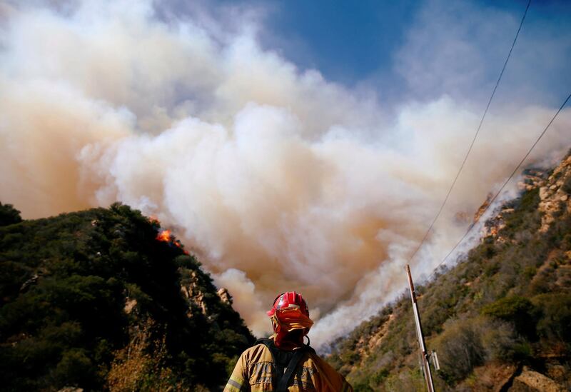 Firefighters battle the Woolsey Fire as it continues to burn in Malibu, California. Reuters