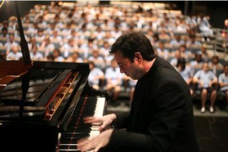 The concert pianist Ioannis Potamousis performs for children at the British School Al Khubairat in Abu Dhabi.