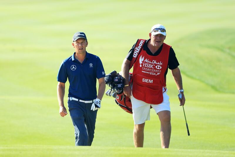 Marcel Siem of Germany wand his caddie walk on the 13th hole at Abu Dhabi Golf Club. Andrew Redington / Getty Images