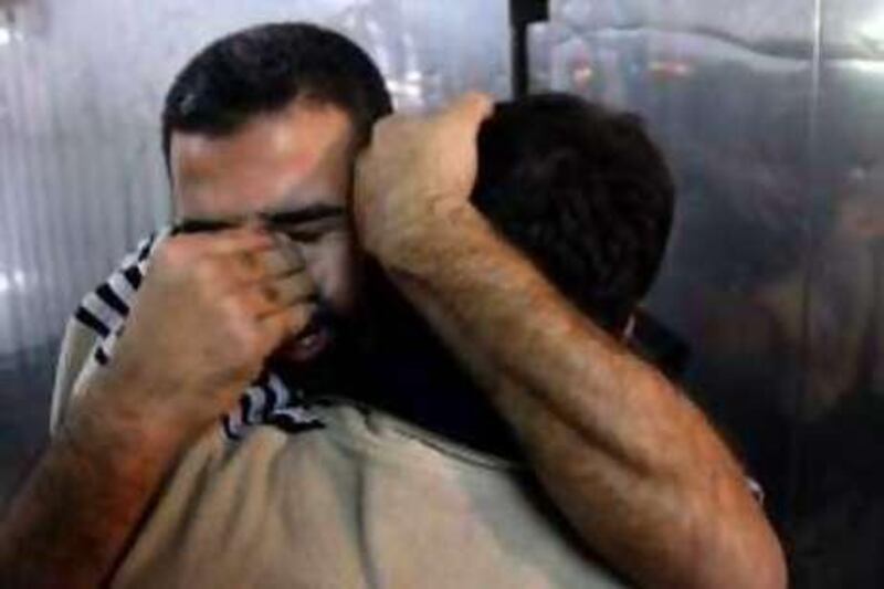 A Palestinian man mourns the loss of a relative, killed in an Israeli air strike, at the mortuary of a hospital in Gaza City on November 16, 2008.  An Israeli air strike killed four armed Palestinians after two rockets fired from Gaza hit Israel today as its leaders prepared to review its crippling blockade of the aid-dependent strip. Interim Israeli Prime Minister Ehud Olmert said that the truce with the Islamist Hamas movement in Gaza was "shattered" and that he had ordered security chiefs to drawn up plans to end its rule. AFP PHOTO/MOHAMMED ABED *** Local Caption ***  717237-01-08.jpg