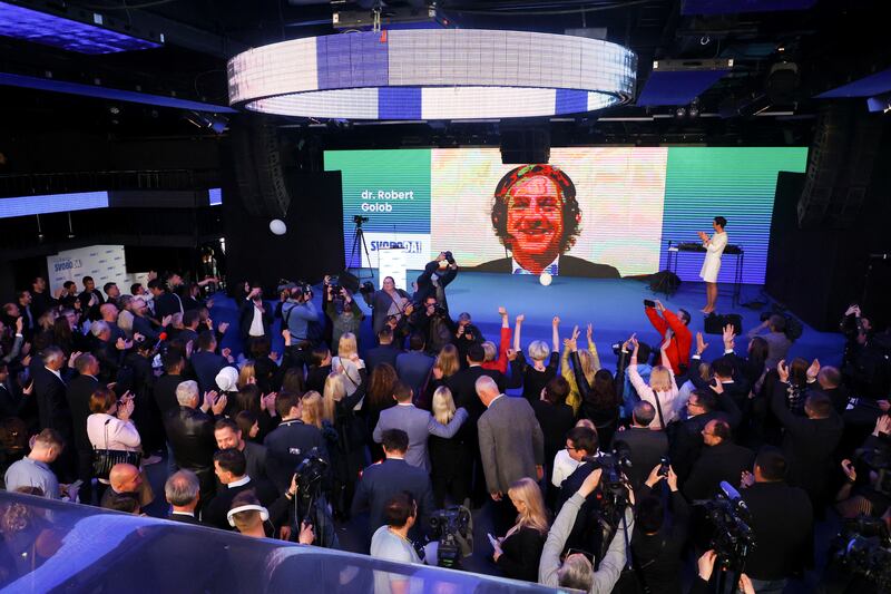 The leader of the Freedom Movement, Robert Golob, appears on screen at the party headquarters in Ljubljana, Slovenia, on April 24. Reuters