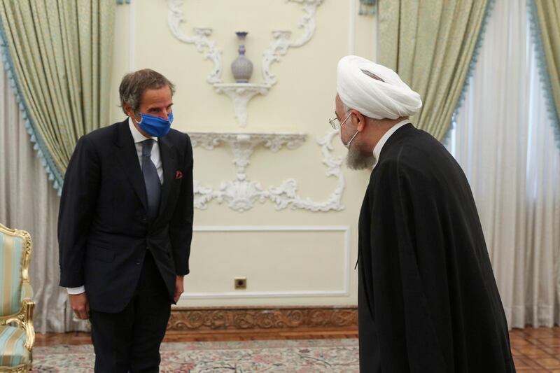 In this photo released by the official website of the office of the Iranian Presidency, President Hassan Rouhani, right, welcomes Director General of International Atomic Energy Agency, IAEA, Rafael Mariano Grossi for their meeting in Tehran, Iran, Wednesday, Aug. 26, 2020. The U.N. nuclear watchdog agency said Wednesday that Tehran has agreed to allow inspectors in to two sites where Iran is suspected of having stored or used undeclared nuclear material. (Iranian Presidency Office via AP)