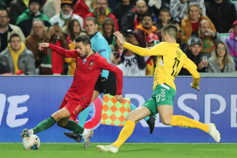 Portugal midfielder Bernardo Silva, left, takes on Lithuania's Arvydas Novikovas. EPA
