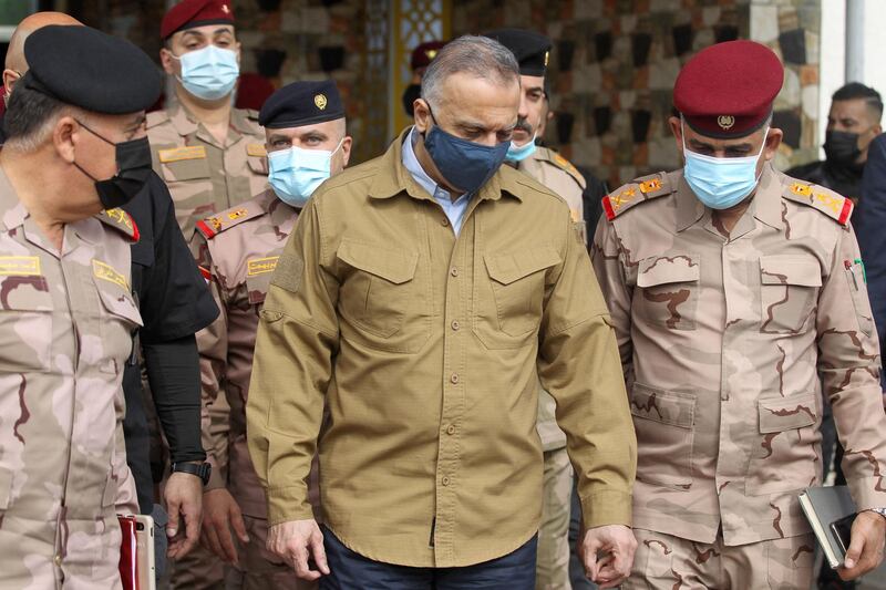 Prime Minister Mustafa Al Kadhimi  visits the army headquarters in Tarmiyah, Iraq, following the clashes. AFP