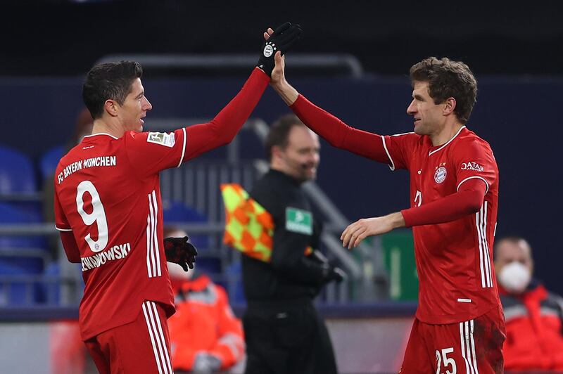 Robert Lewandowski celebrates with teammate Thomas Muller after scoring Bayern's second goal. Getty