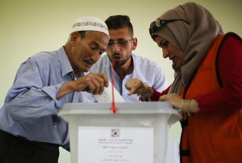 A Palestinian man casts his vote at a polling station in the West Bank city of Nablus during municipal elections on May 13, 2017. Majdi Mohammed / AP Photo
