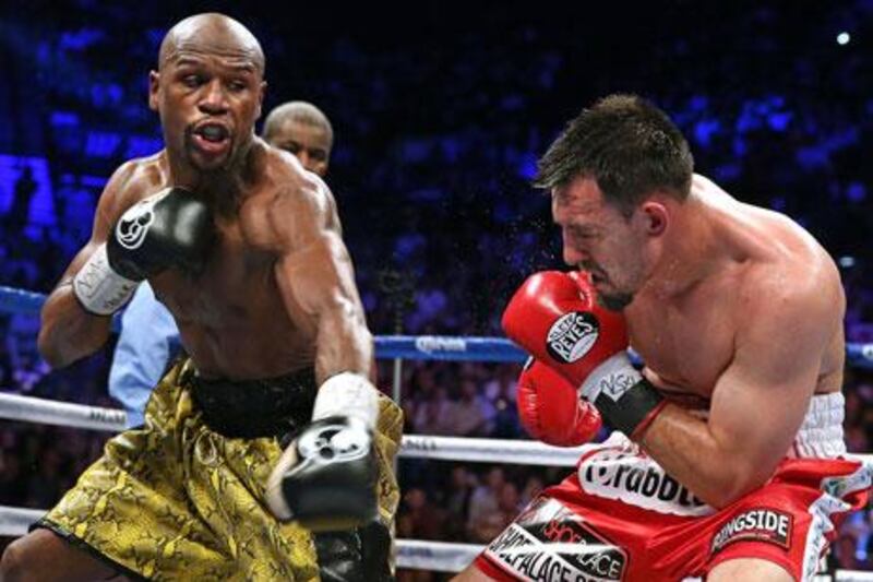 Floyd Mayweather Jr, left, landed an astonishing 60 per cent of his power punches en route to a unanimous 12-round decision. John Gurzinski / AFP