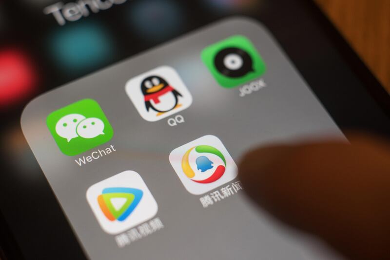 The icons for Tencent Holdings Ltd. applications WeChat, clockwise from top left, QQ, JOOX, Tencent News and Tencent Video are arranged for a photograph on an Apple Inc. iPhone in an arranged photograph taken in Hong Kong, China, on Wednesday, July 26, 2017. Tencent is scheduled to release second-quarter earnings figures on Aug 16. Photographer: Anthony Kwan/Bloomberg