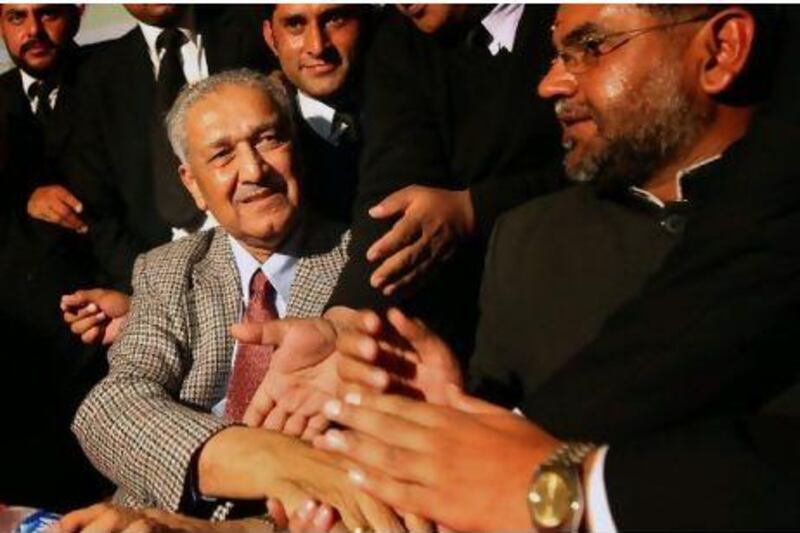 Pakistani nuclear scientist Abdul Qadeer Khan shakes hands with his supporters: Khan admitted in 2004 that he leaked nuclear secrets to Iran, North Korea and Libya, although he later retracted his remarks. Behrouz Mehri / AFP Photo