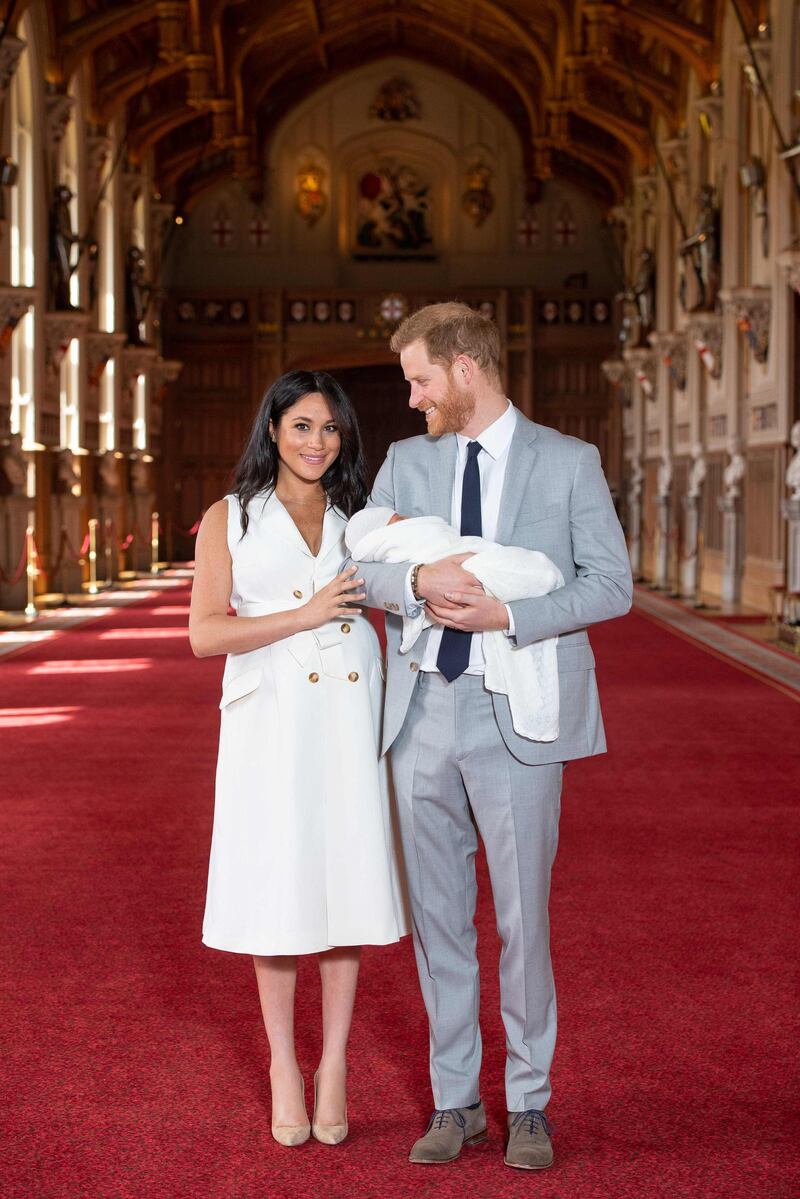 Britain's Prince Harry, Duke of Sussex and Meghan, Duchess of Sussex, pose for a photo with their newborn baby son in St George's Hall at Windsor Castle in Windsor, west of London on May 8, 2019. AFP