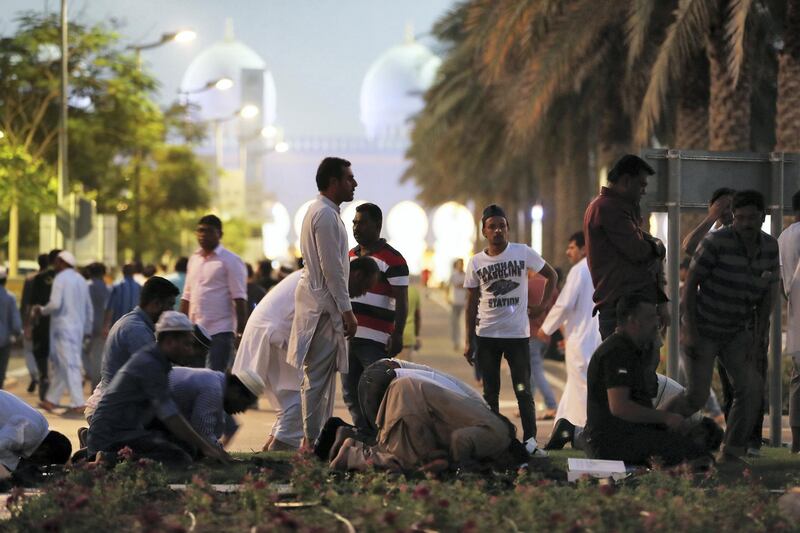 ABU DHABI,  UNITED ARAB EMIRATES , May 6 – 2019 :- People praying after breaking their fast on the First day of Ramadan at the Sheikh Zayed Grand Mosque in Abu Dhabi. ( Pawan Singh / The National ) For News/Online/Big Picture/ Instagram