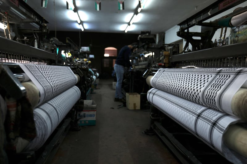Workers producing the traditional keffiyeh in Hebron. AFP