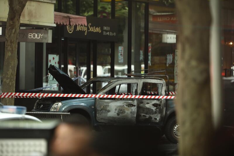 A burnt out car is seen in Bourke St . Getty Images