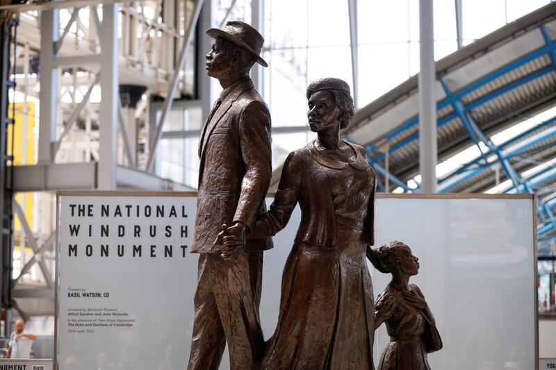 The monument, created by Jamaican artist Basil Watson, features a man, woman and child dressed smartly and standing on top of luggage. Reuters