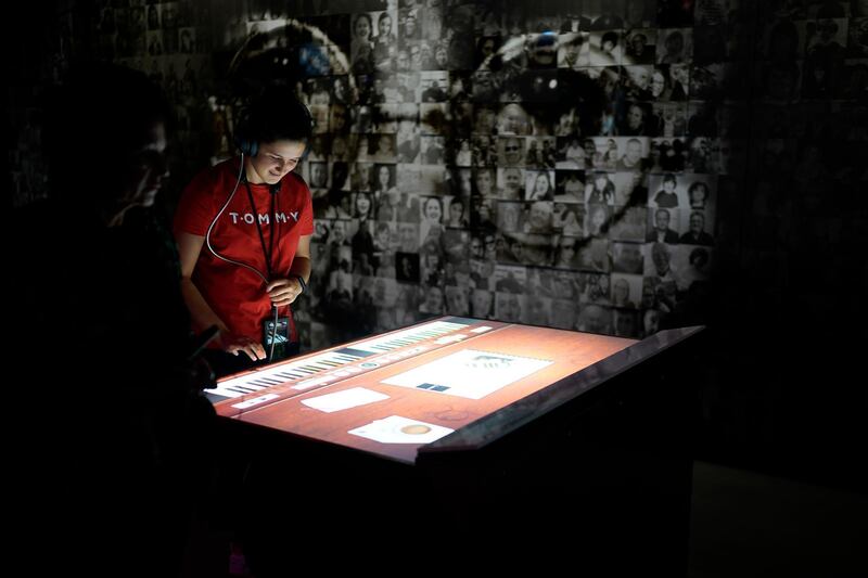 People use interactive displays at the Strawberry Field visitor centre.