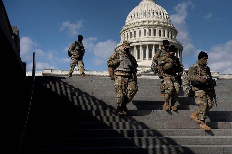(FILES) In this file photo taken on March 04, 2021 members of the National Guard patrol the grounds of the US Capitol in Washington, DC. The US Capitol stood unprotected by National Guard troops for the first time in nearly five months May 24, 2021 as concerns about right-wing extremist threats have diminished since the January 6 attacks. / AFP / Brendan Smialowski
