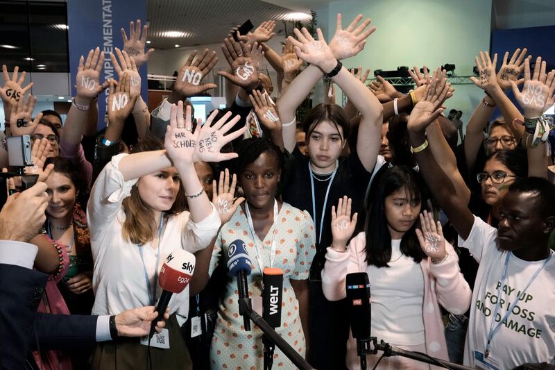 Activists including 11-year-old Licypriya Kangujam from India (in a pink top) protest against Germany's climate policy at the summit.  AP Photo