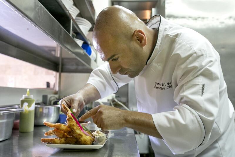 Chef Danny Kattar from InterContinental Abu Dhabi preparing coconut breaded shrimp with peanut sauce. Mona Al Marzooqi / The National