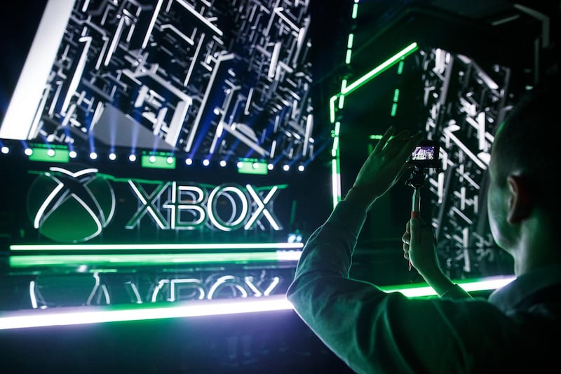 An attendee takes photographs before the Microsoft Corp. Xbox event ahead of the E3 Electronic Entertainment Expo in Los Angeles, California, U.S., in Los Angeles, California, U.S., on Sunday, June 9, 2019. Microsoft introduced its new Xbox console that will be four times more powerful than the current generation Xbox One X, thanks to an AMD processor that allows for 120 frames per second. Photographer: Patrick T. Fallon/Bloomberg