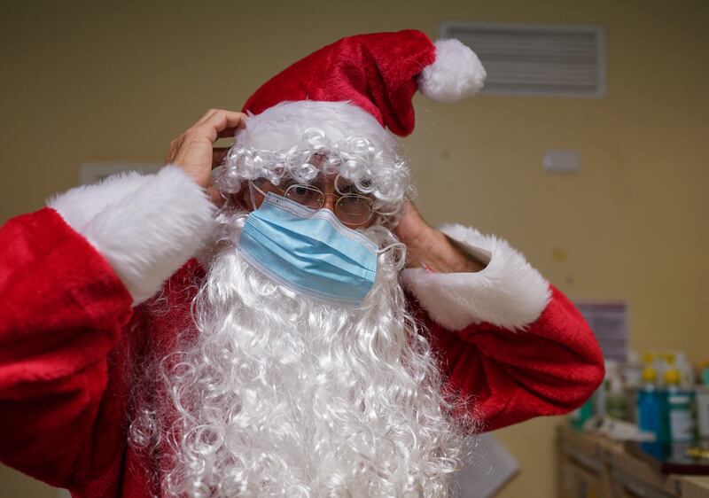 Pastor David Shrimpton, 57, known as the ‘flying padre’, puts on a face mask as he prepares to speak to pupils about Christmas at a school in Broken Hill, Australia. Since 2003, he has flown to some of Australia’s most isolated communities to preach. Reuters