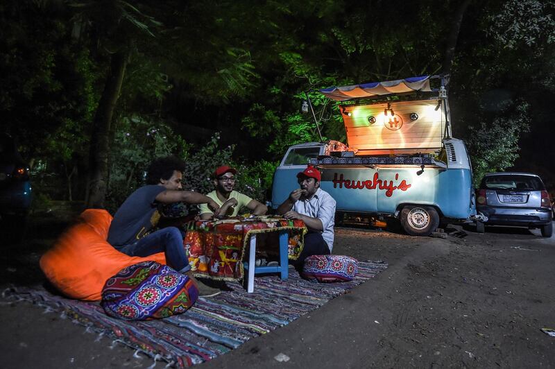 Kareem Mahmoud, a 32-year-old Egyptian, prepares a dish of fava beans for customers from a novelty food cart in the capital Cairo's southern suburb of Maadi. AFP