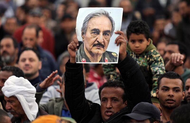 A man holds a poster of Eastern Libyan military commander Khalifa Haftar during a rally demanding Haftar to take over, after a U.N. deal for a political solution missed what his supporters said was a self-imposed deadline on Sunday, in Benghazi, Libya, December 17, 2017. REUTERS/Esam Omran Al-Fetori