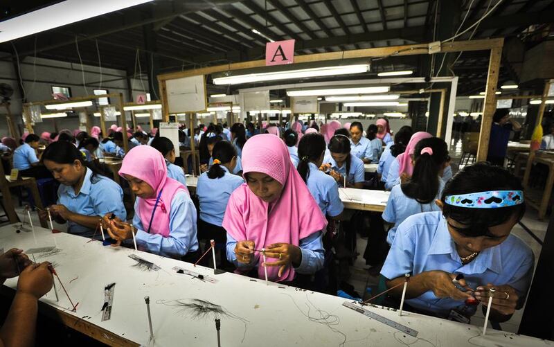 Workers at the PT Royal Korindah factory make false eyelashes destined for cosmetics firms such as L’Oreal, MAC and Eylure;. Gethin Chamberlain for The National

