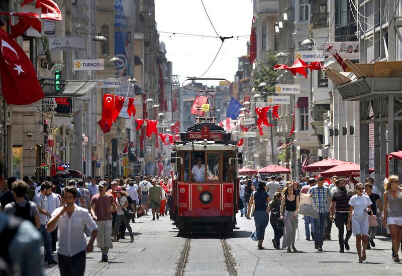 People walk in central Istanbul's Istiklal Avenue, the main shopping road of Istanbul, Monday, July 25, 2016. (AP Photo/Lefteris Pitarakis)