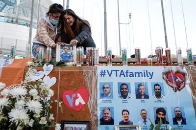 Women cry as they attend a vigil for the victims of a shooting in San Jose, California, on May 27, 2021. A public transit worker shot dead eight people at a California rail yard on May 26 before turning his gun on himself as police arrived, officials said after the latest mass shooting to hit the United States. / AFP / Amy OSBORNE
