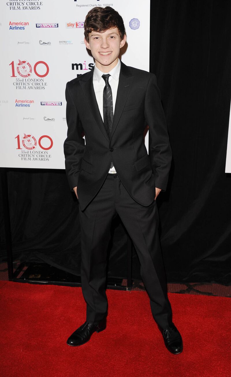 Tom Holland, in a black suit, attends the London Critics' Circle Film Awards on January 20, 2013. Getty Images