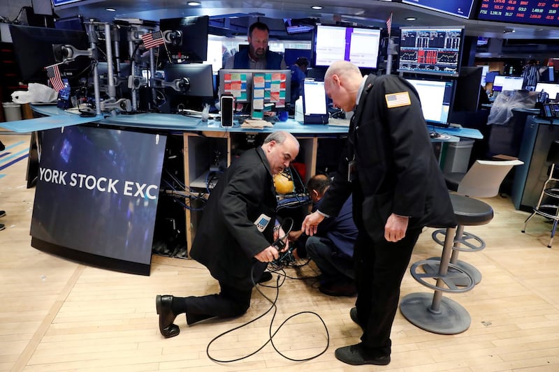 Traders remove computer equipment to work from home on the floor of the New York Stock Exchange (NYSE) as the building prepares to close indefinitely due to the coronavirus disease (COVID-19) outbreak in New York, U.S.  REUTERS