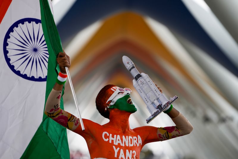 A man in Ahmedabad cheers in anticipation of the successful landing. AP