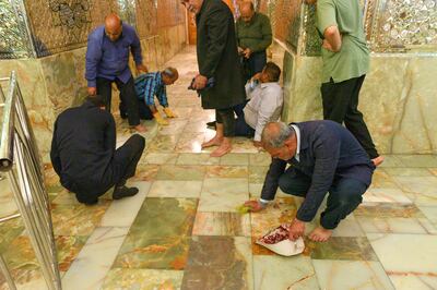 Shah Cheragh shrine staff cleaning up after the attack in Shiraz, Iran. Reuters