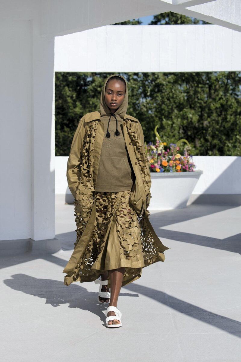 Military camouflage is remade into this loose coat and skirt for spring / summer 2022. Courtesy Qasimi