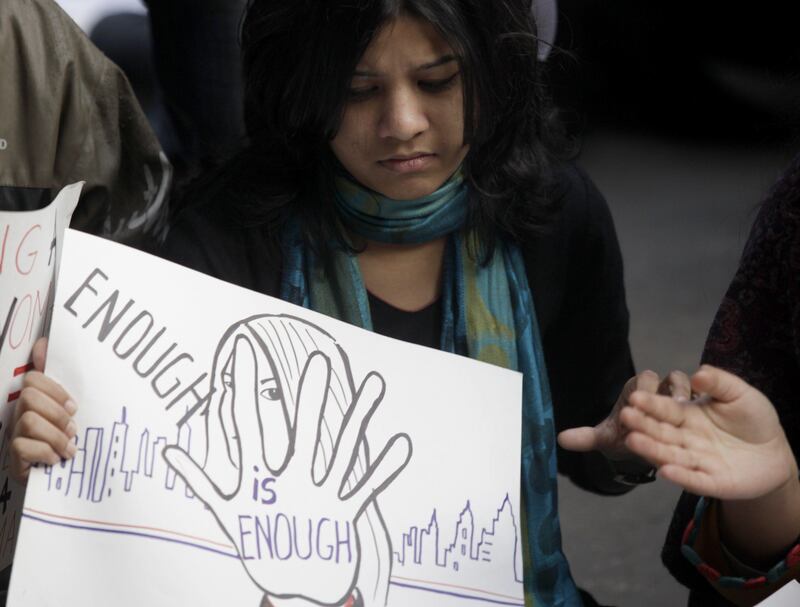 An Indian protester holds a banner during a rally in New Delhi on December 30, 2012, following the cremation of a gangrape victim in the Indian capital. The victim of a gang-rape and murder which triggered an outpouring of grief and anger across India was cremated at a private ceremony, hours after her body was flown home from Singapore. A student of 23-year-old, the focus of nationwide protests since she was brutally attacked on a bus in New Delhi two weeks ago, was cremated away from the public glare at the request of her traumatised parents. AFP PHOTO/ ANDREW CABALLERO-REYNOLDS
 *** Local Caption ***  173918-01-08.jpg