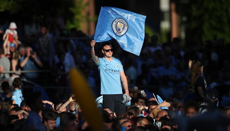 Fans during the Manchester City trophy parade in Manchester city centre. Lynne Cameron / Getty Images