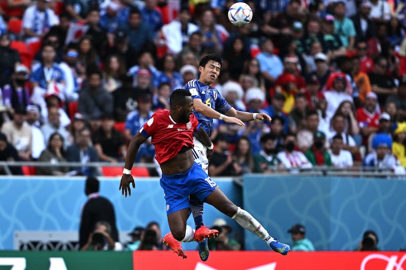 Costa Rica's Francisco Calvo and Japan's Wataru Endo jump for the ball. AFP