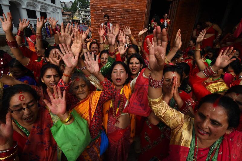 Nepali Hindu women dance after paying homage to Shiva, the Hindu god of destruction, as they celebrate the Teej festival at the Pashupatinath temple in Kathmandu. Prakash Mathema/AFP