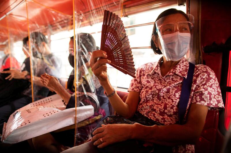Passengers seated in between plastic barriers, wear face masks and face shields to help curb Covid-19 infections, in Quezon City, Metro Manila, Philippines. Reuters