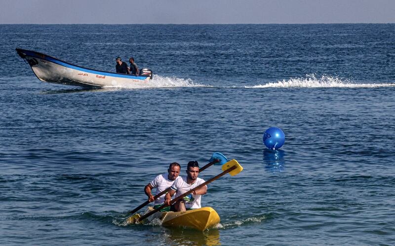 Palestinians take part in a local canoeing championship off the coast of Gaza city.