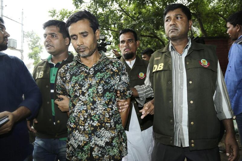 Bangladesh police arrest Shariful Islam, centre, in connection with the murder of rights activist Xulhaz Mannan and his friend Tonoy Fahim, in Dhaka, Bangladesh on May 15, 2016. EPA