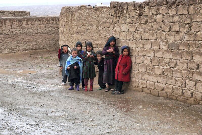 Pictured: A group of children huddle together in an unofficial IDP camp in Herat amid a downpour of rain. 
Photo by Charlie Faulkner
May 2021