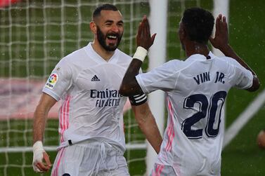 Real Madrid's French forward Karim Benzema (L) celebrates with Real Madrid's Brazilian forward Vinicius Junior after scoring a goal during the Spanish League football match between Real Madrid CF and SD Eibar at the Alfredo di Stefano stadium in Valdebebas on the outskirts of Madrid on April 3, 2021. / AFP / GABRIEL BOUYS