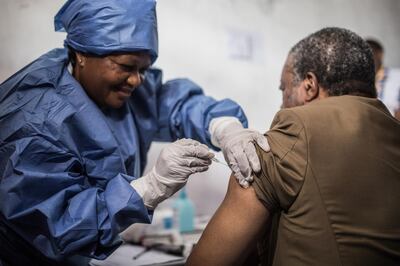 Doctor Jean-Jacques Muyembe Tamfun is getting inoculated with an Ebola vaccine on November 22, 2019 in Goma. (Photo by PAMELA TULIZO / AFP)