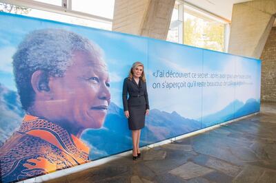 Marianna V. Vardinoyannis, Greek philanthropist and world advocate for human rights and children’s welfare with a poster of the man she describes as 'a legendary personality of the 20th century'. Courtesy Marianna V. Vardinoyannis