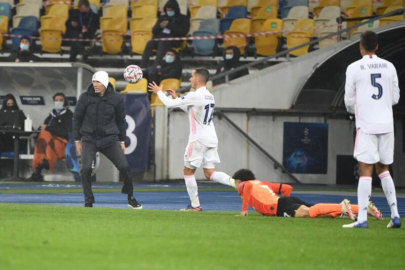 Real Madrid forward Lucas Vazquez goes to catch the ball as Zinedine Zidane watches on from the touchline. AFP